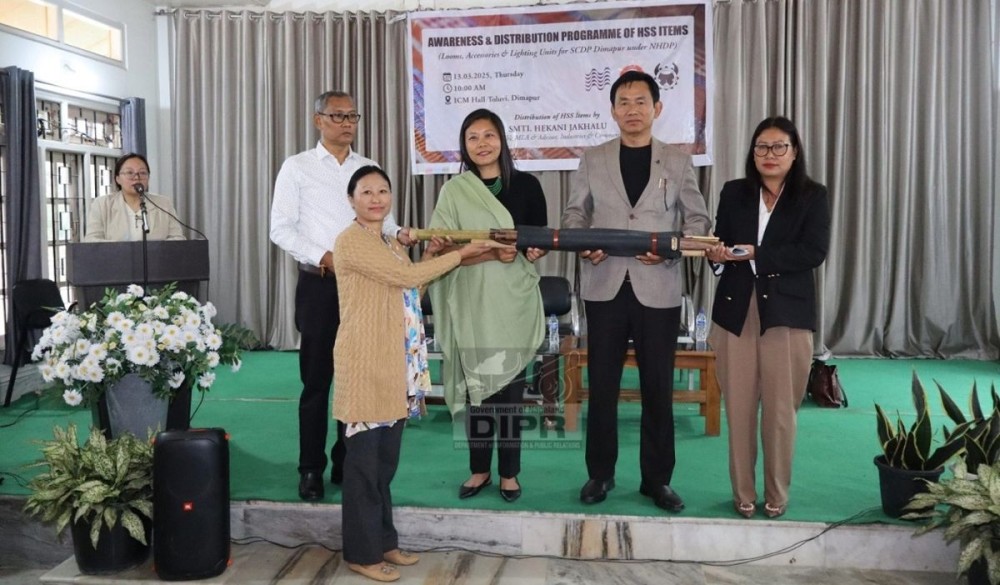 MLA & Advisor Hekani Jakhalu and other officials during the distribution programme of Handloom Sector Support items at ICM Hall, Toluvi, Dimapur on March 13. (DIPR Photo)